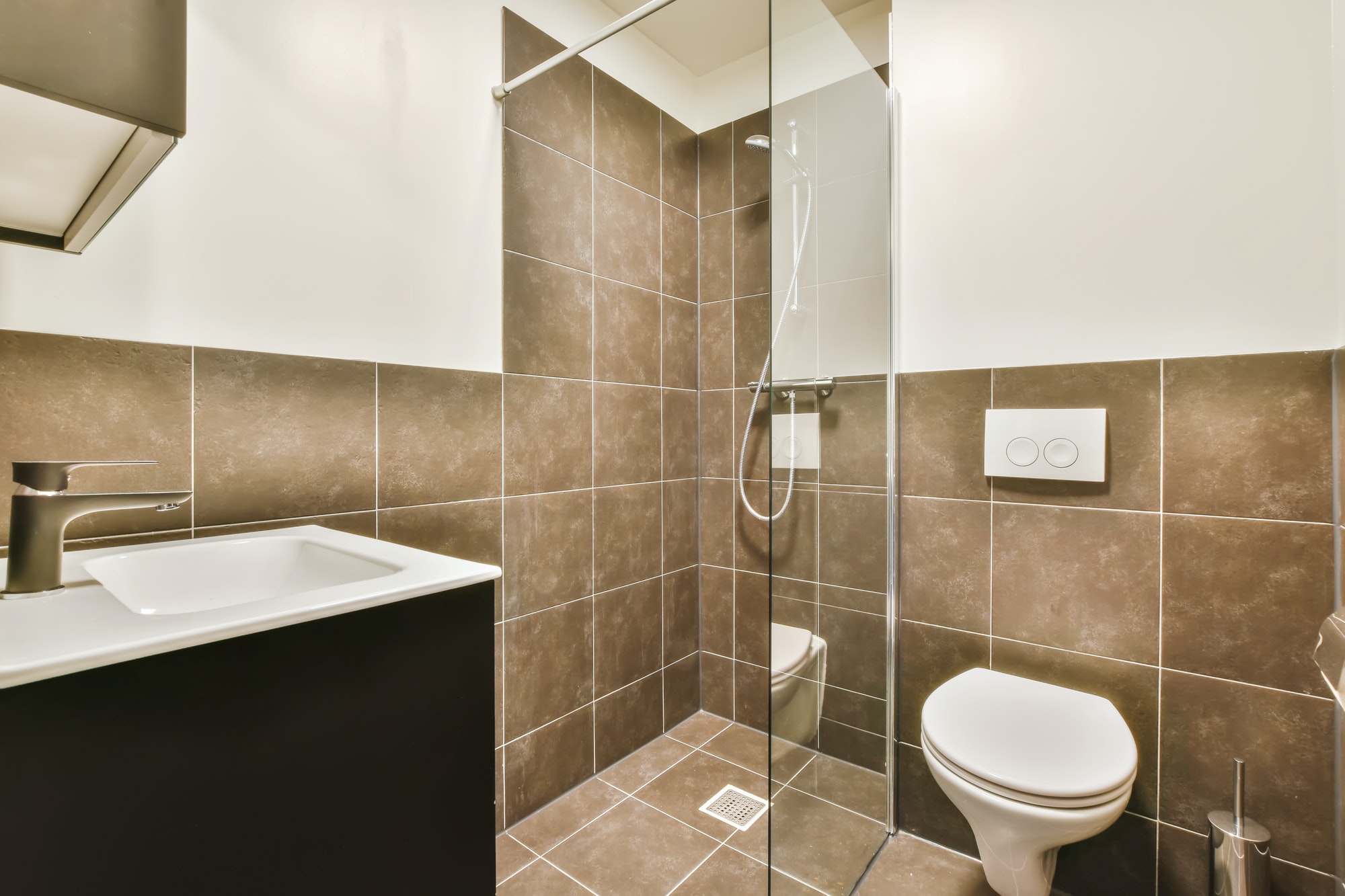 Lovely bathroom design with brown tiles