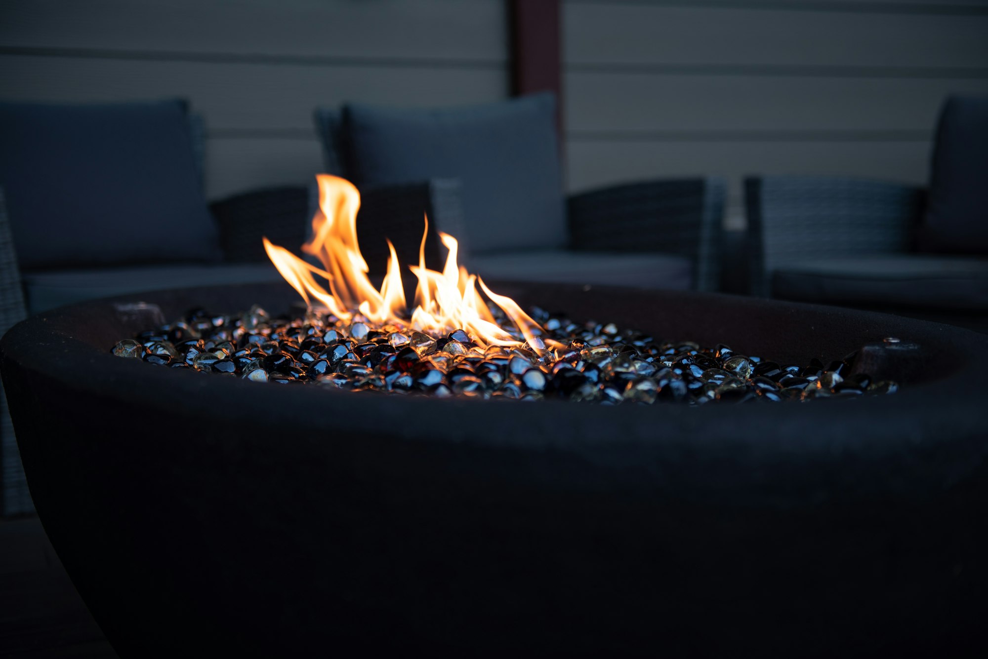 Outdoor firepit table lit at dusk