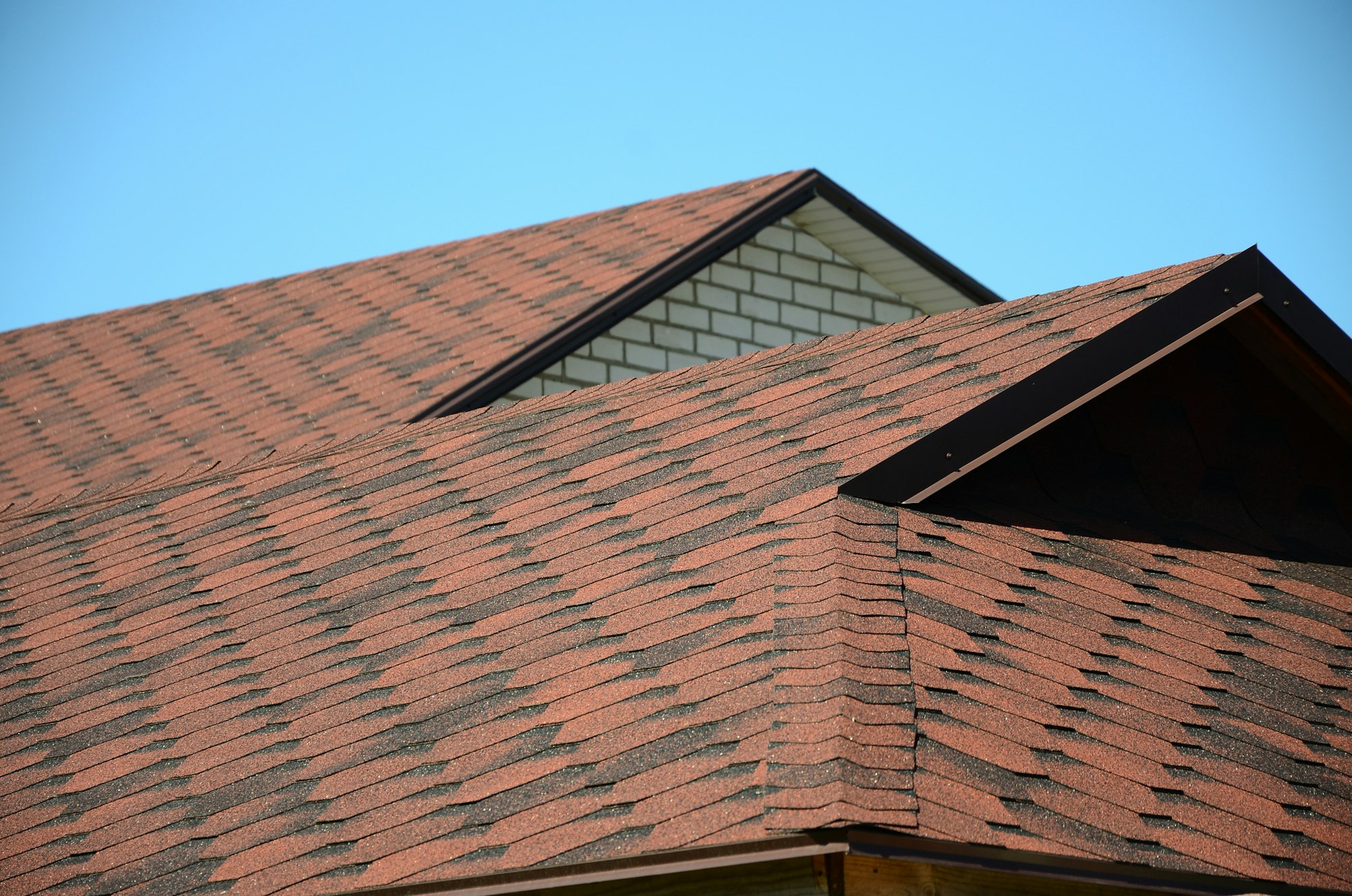 The roof is covered with bituminous shingles of brown color. Quality Roofing